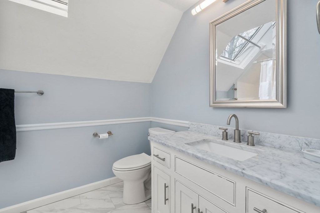 24 Parmenter Road Framingham, MA 01701 - Photo 36 of 42 a bathroom with a granite countertop sink a toilet and a mirror
