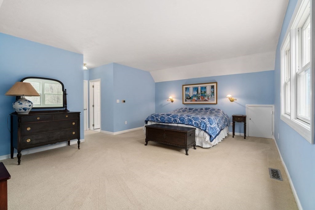 24 Parmenter Road Framingham, MA 01701 - Photo 38 of 42 a spacious bedroom with a bed and a lamp on dresser