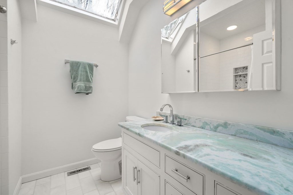 24 Parmenter Road Framingham, MA 01701 - Photo 40 of 42 a bathroom with a granite countertop sink a toilet and mirror