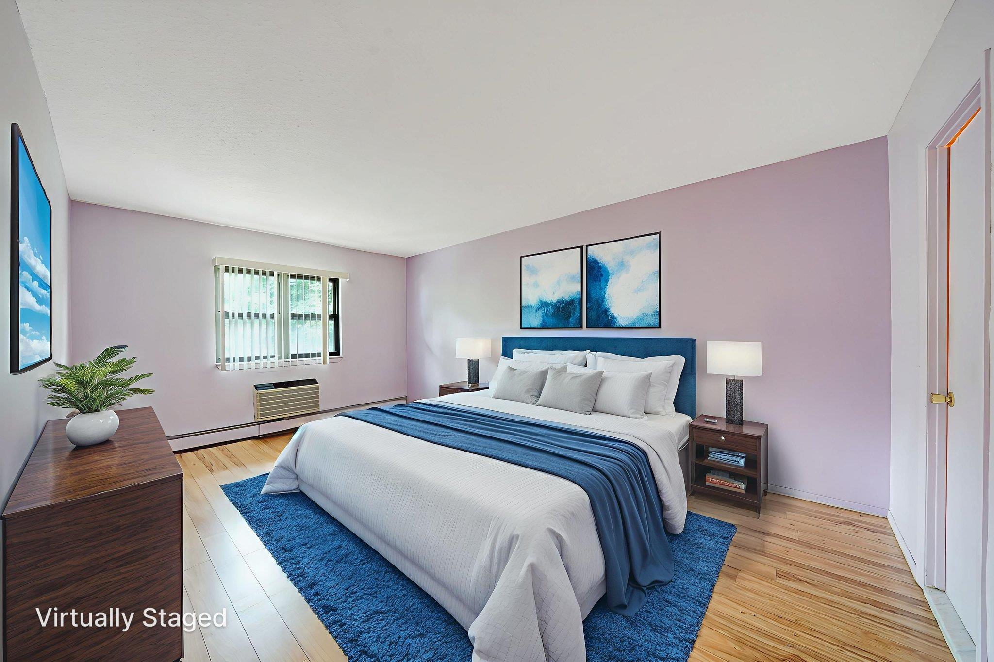 504 Julius Road, Unit 7C Queens, NY 11356 - Photo 13 of 22 a bedroom with a bed and wooden floor