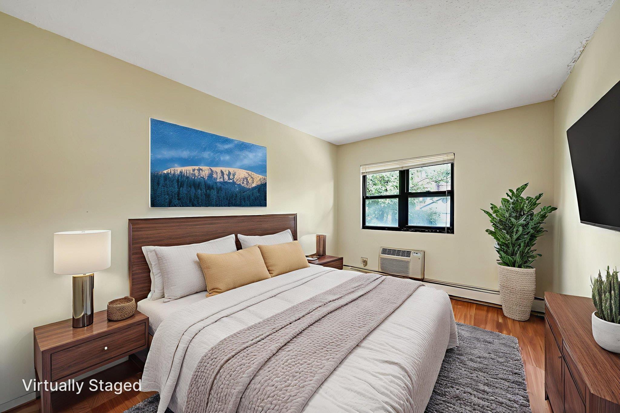 504 Julius Road, Unit 7C Queens, NY 11356 - Photo 15 of 22 a bedroom with a large bed and a flat screen tv