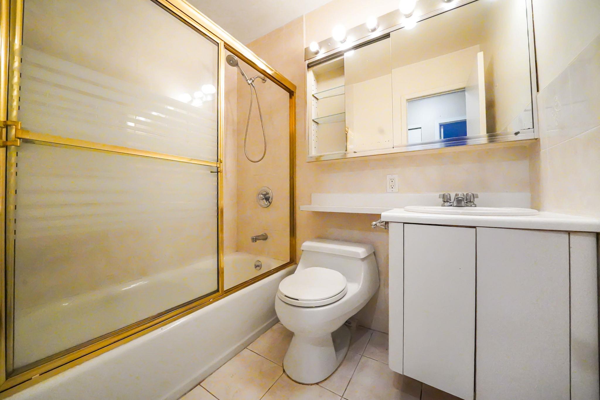 504 Julius Road, Unit 7C Queens, NY 11356 - Photo 17 of 22 a bathroom with a granite countertop sink toilet and shower