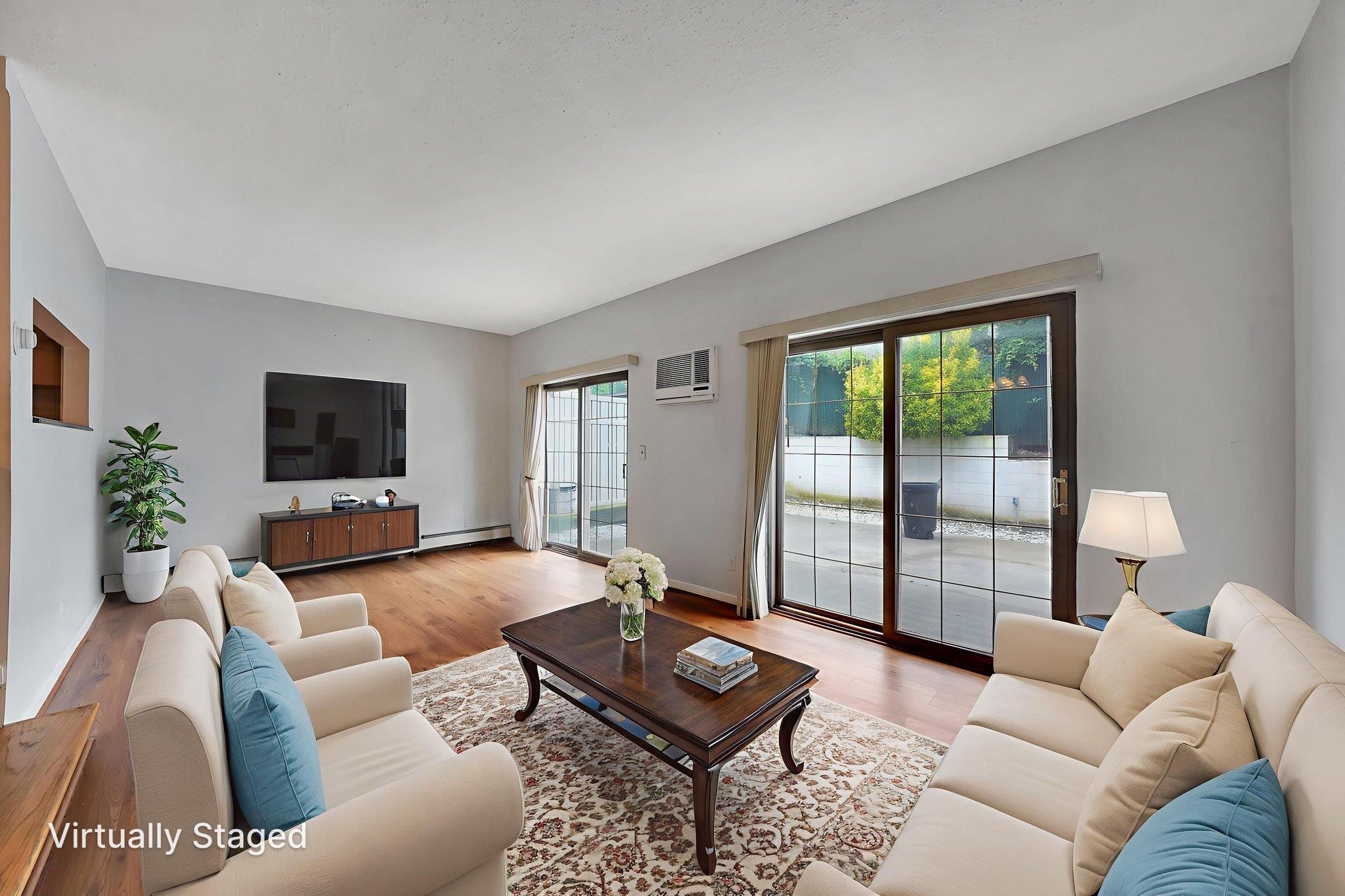 504 Julius Road, Unit 7C Queens, NY 11356 - Photo 8 of 22 a living room with furniture and a flat screen tv