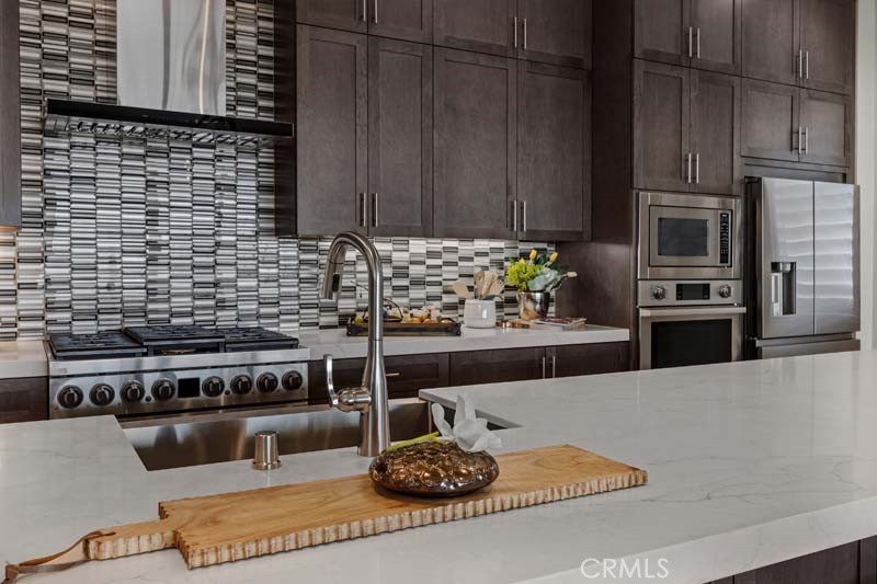 6505 Canyon Oaks Drive Simi Valley, CA 93063 - Photo 9 of 22 a kitchen with stainless steel appliances wooden cabinets a stove and a refrigerator