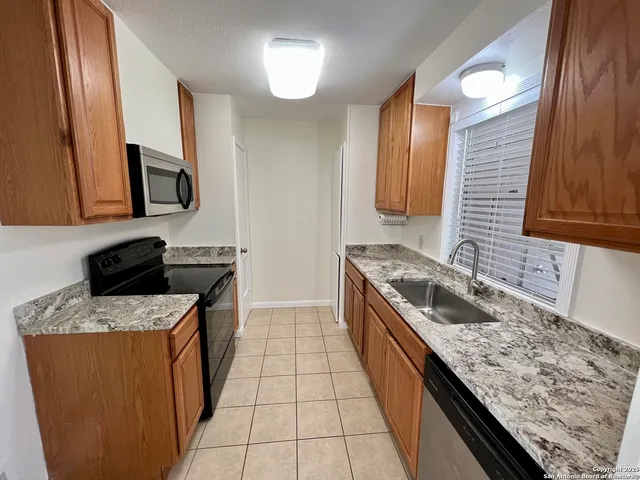 a kitchen with granite countertop cabinets sink and a granite counter tops