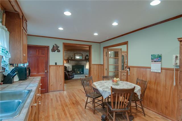 7720 Caney Fork Road Fairview, TN 37062 - Photo 8 of 20 a dining room with furniture a rug and wooden floor
