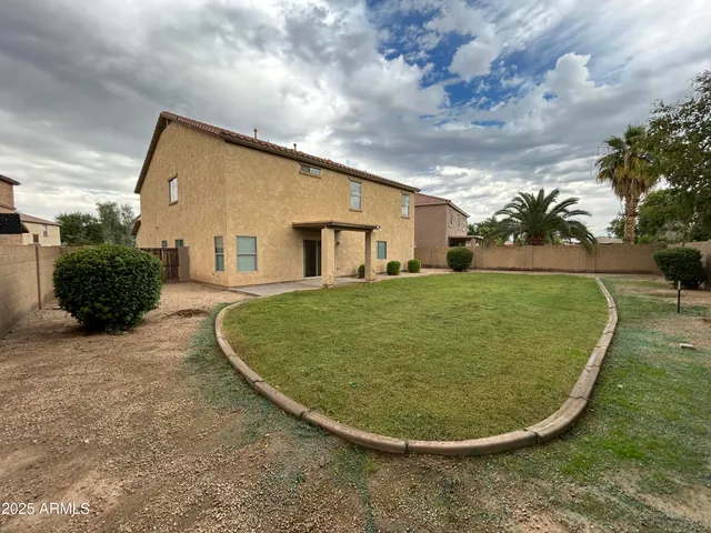 a view of a house with a backyard