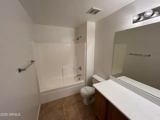 a bathroom with a toilet a sink and shower