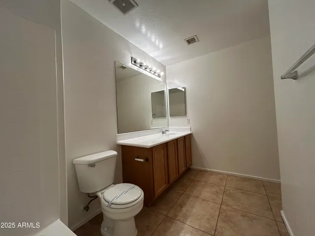 a bathroom with a sink toilet and a mirror