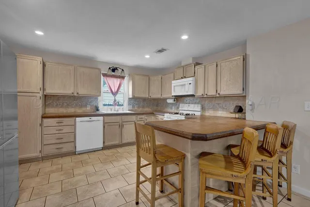 a kitchen with granite countertop a sink and cabinets
