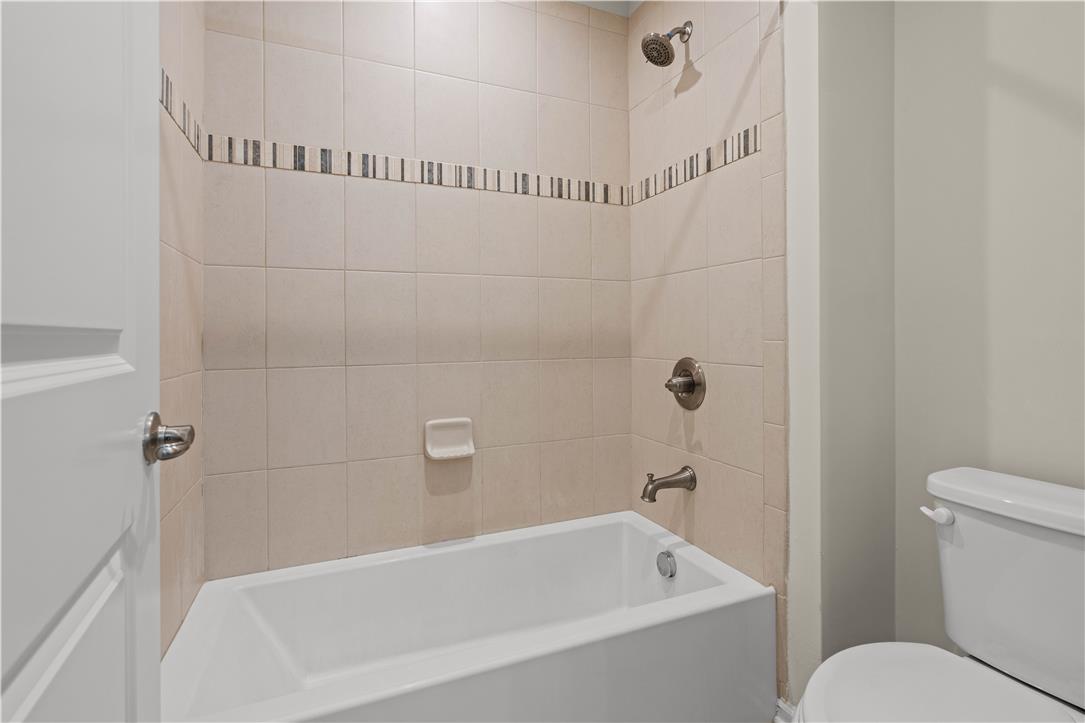 4758 Rafi Road Easton, PA 18045 - Photo 26 of 55 A pristine bath featuring tiled walls and a shower-tub combination for daily refreshment.