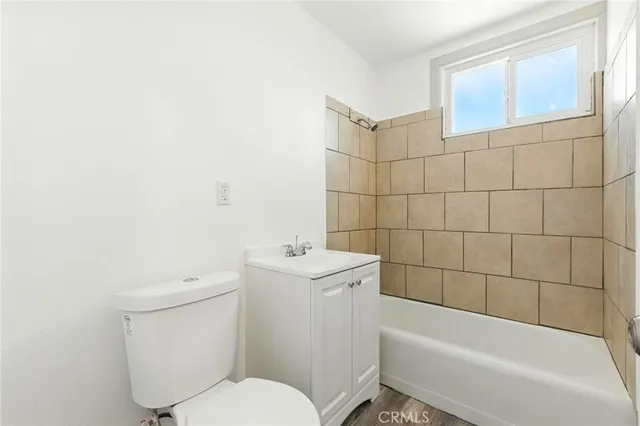 a white toilet sitting next to a bath tub