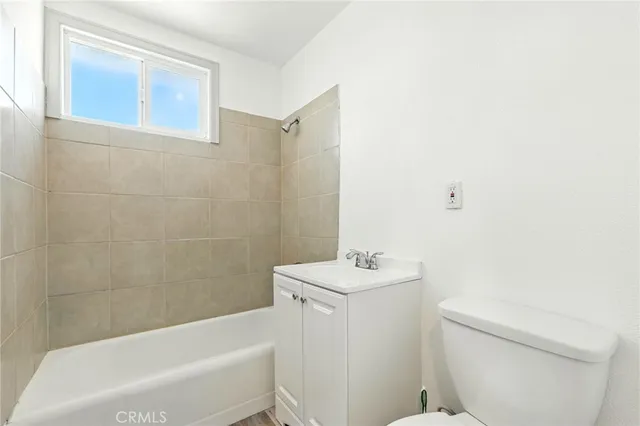a bathroom with a sink a toilet and bathtub