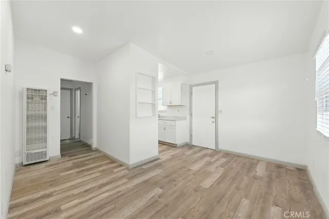 a view of wooden floor and windows in a room
