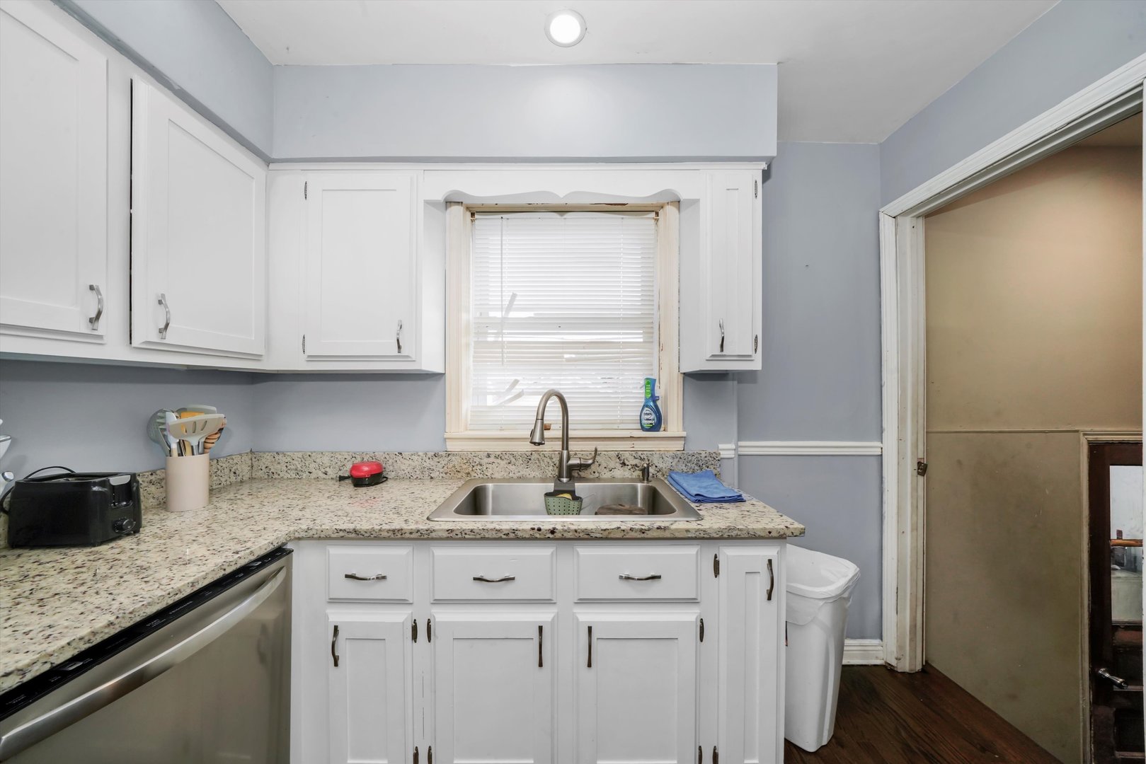 3705 West 65th Place Chicago, IL 60629 - Photo 14 of 31 a kitchen with granite countertop white cabinets and white appliances