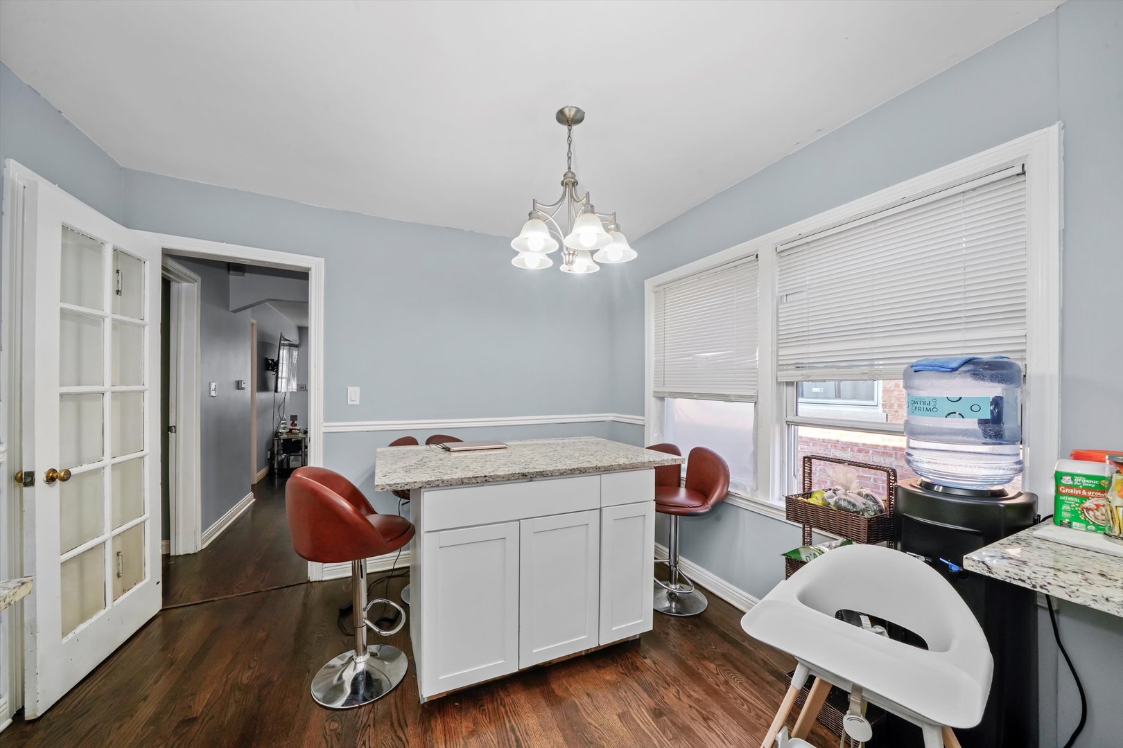 3705 West 65th Place Chicago, IL 60629 - Photo 15 of 31 a kitchen that has a table chair and wooden floor