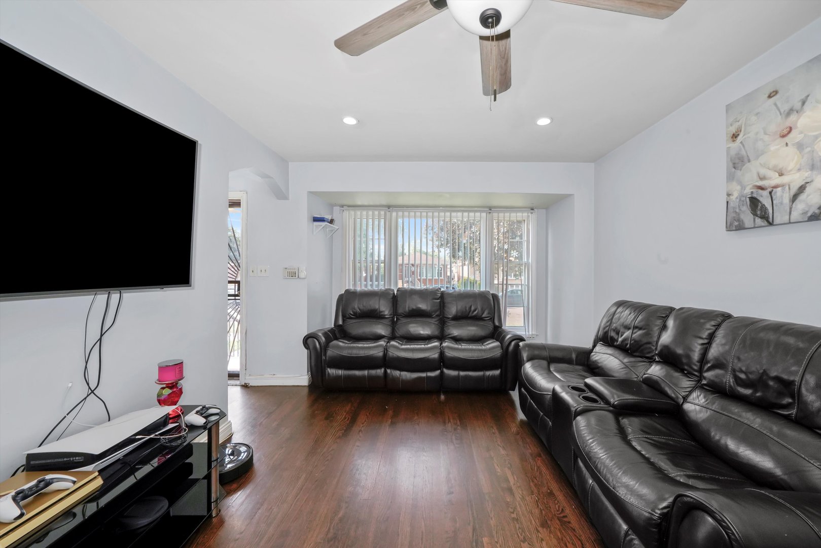 3705 West 65th Place Chicago, IL 60629 - Photo 3 of 31 a living room with furniture and a flat screen tv