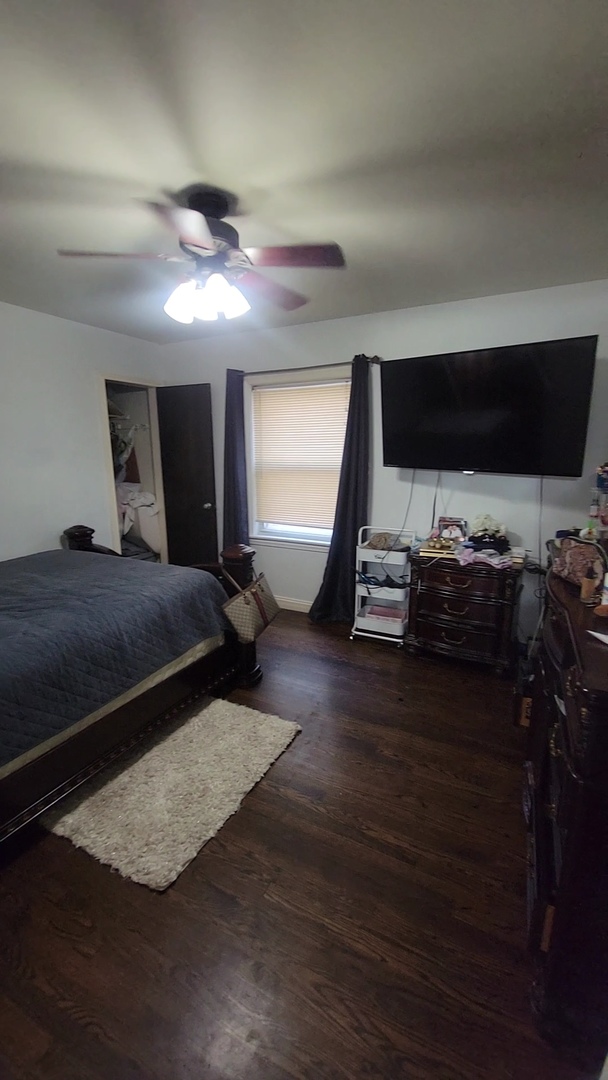 3705 West 65th Place Chicago, IL 60629 - Photo 9 of 31 a bedroom with furniture and a flat screen tv