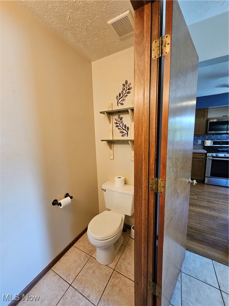 6247 Hathaway Road Cleveland, OH 44125 - Photo 23 of 42 Bathroom with tile patterned flooring, a textured ceiling, and decorative backsplash