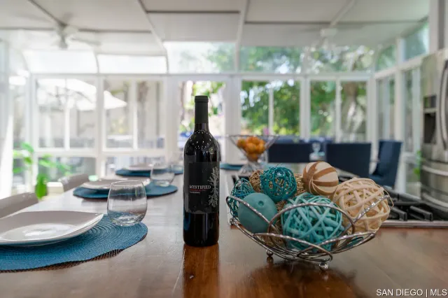 a view of a house with a yard and potted plants