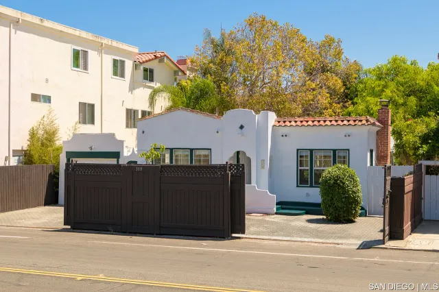 a front view of a house with plants