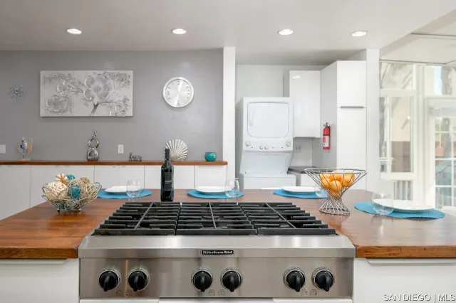 a kitchen with stainless steel appliances granite countertop a stove a sink and a granite counter tops