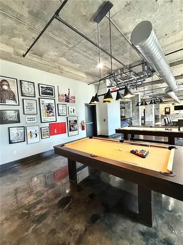 a room with stainless steel appliances kitchen island granite countertop lots of clutter