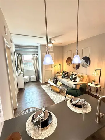 a living room with furniture and a wooden floor