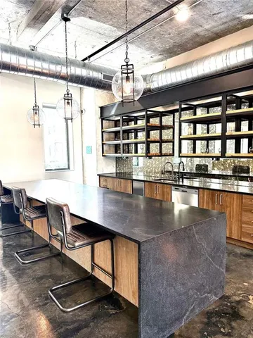 a kitchen with a table chairs and wooden floor