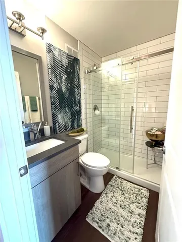 a bathroom with a sink toilet and shower