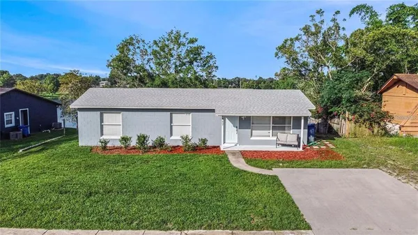 a front view of house with yard and outdoor seating