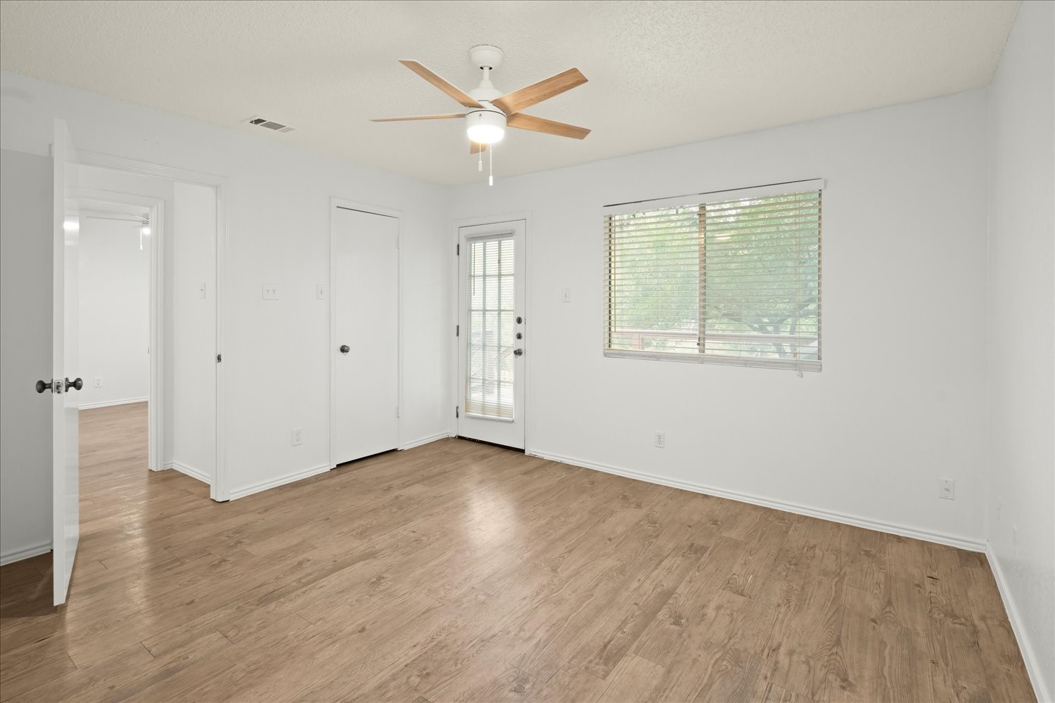 220 Sailmaster Street, Unit A Lakeway, TX 78734 - Photo 17 of 32 an empty room with wooden floor and windows