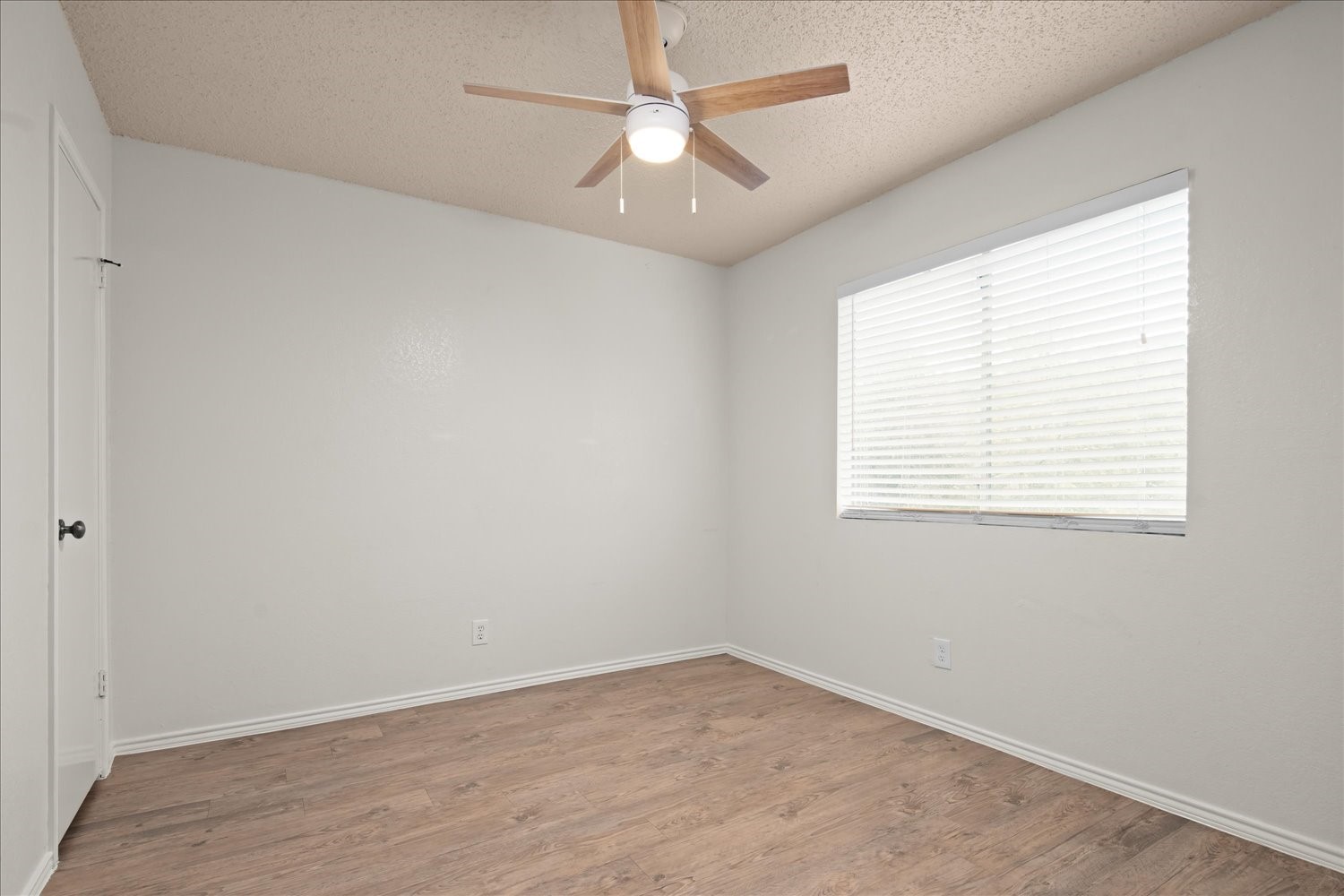 220 Sailmaster Street, Unit A Lakeway, TX 78734 - Photo 19 of 32 an empty room with a window and a fan
