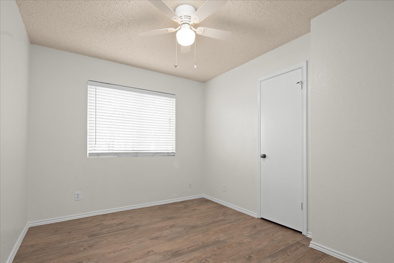 220 Sailmaster Street, Unit A Lakeway, TX 78734 - Photo 20 of 32 wooden floor in an empty room with a window
