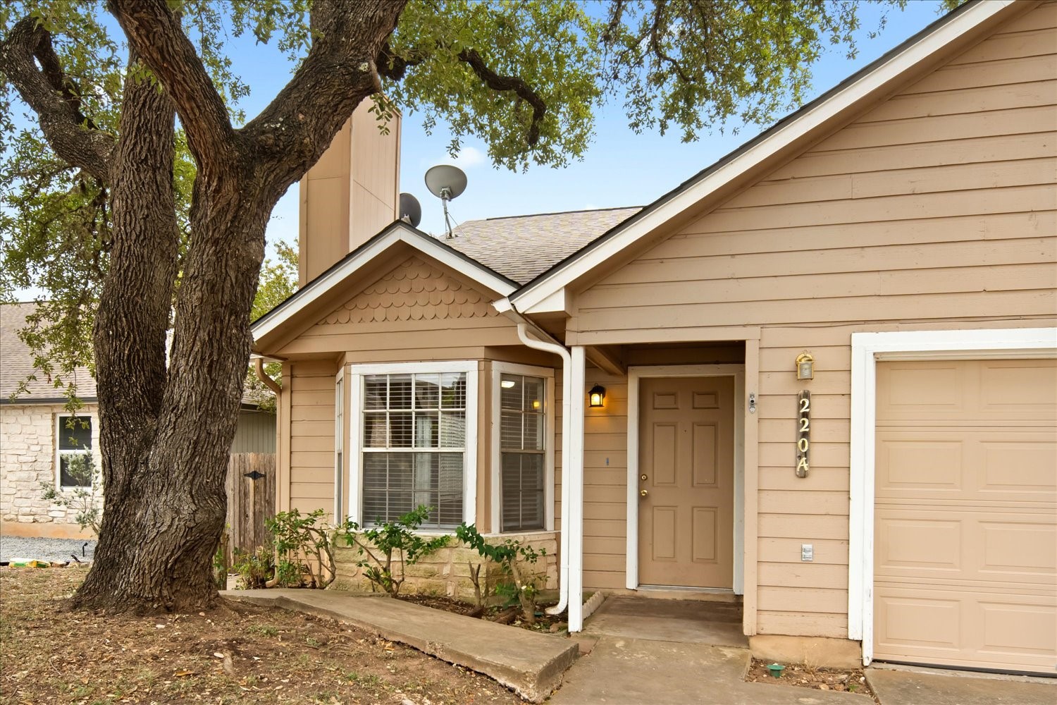 220 Sailmaster Street, Unit A Lakeway, TX 78734 - Photo 2 of 32 a front view of a house with a yard