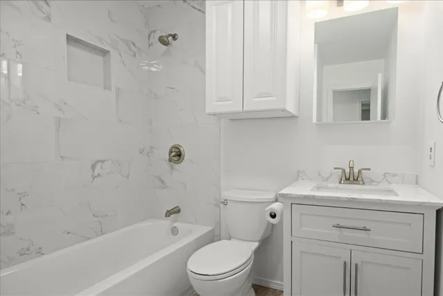 a bathroom with a sink a toilet and vanity