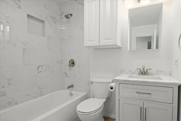 a bathroom with a sink a toilet and vanity