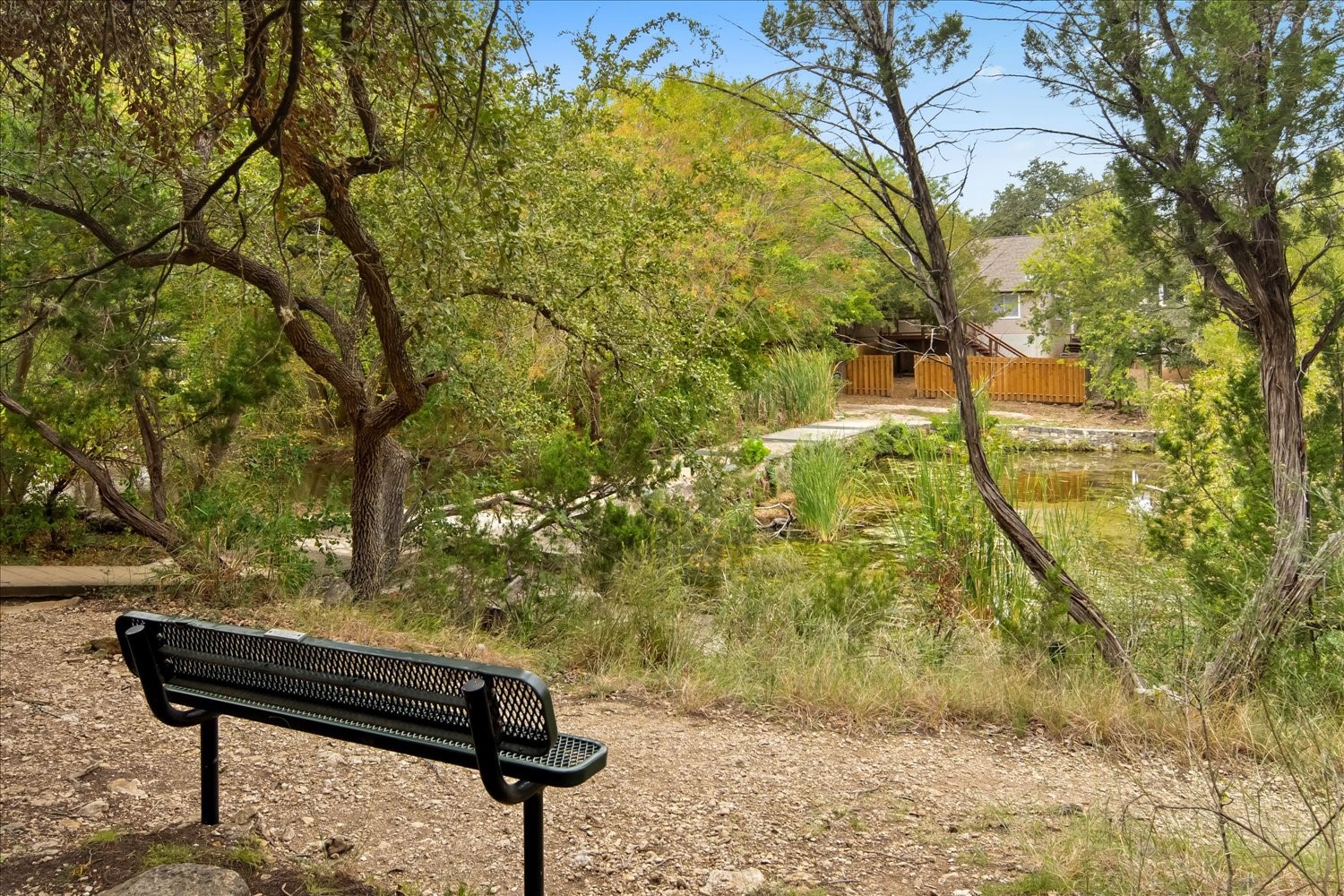 220 Sailmaster Street, Unit A Lakeway, TX 78734 - Photo 4 of 32 a view of a bench in a backyard