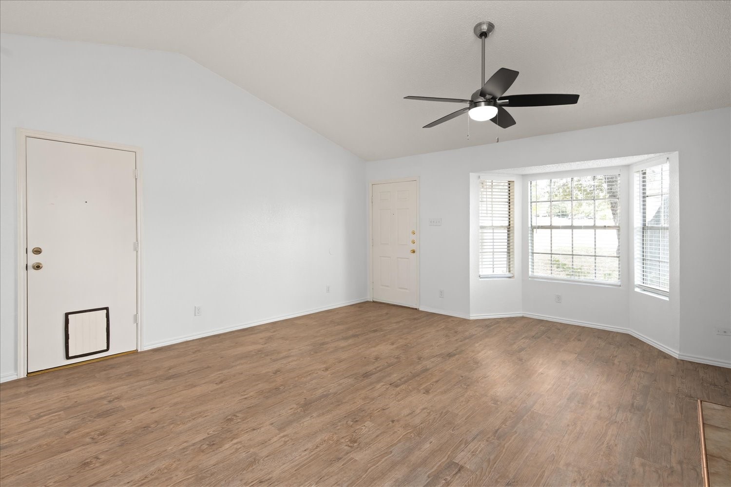 220 Sailmaster Street, Unit A Lakeway, TX 78734 - Photo 10 of 32 a view of empty room with wooden floor and fan