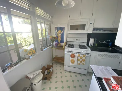 a living room with furniture a rug and a large window