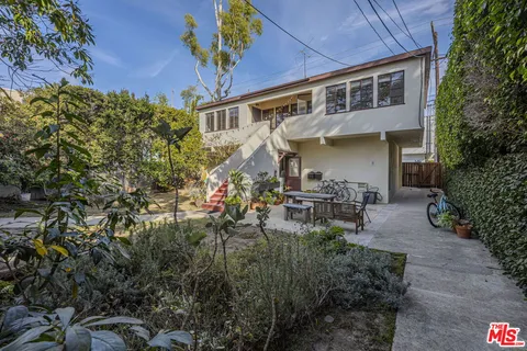 a backyard of a house with yard barbeque oven and outdoor seating