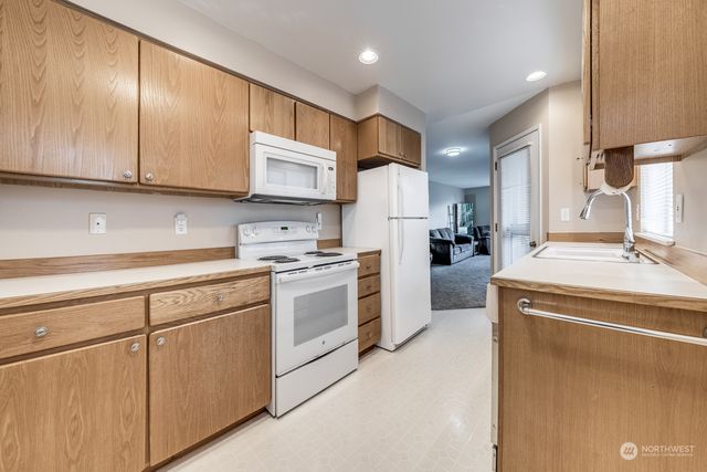 a bathroom with a double vanity sink and mirror with shower