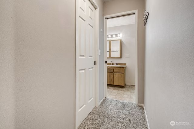 a bathroom with a toilet sink vanity and mirror
