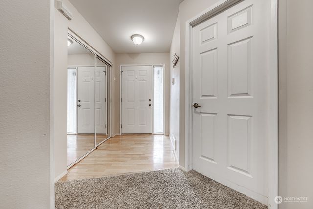 a view of a hallway with wooden shelves