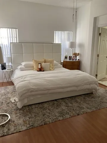 a bedroom with a bed and window