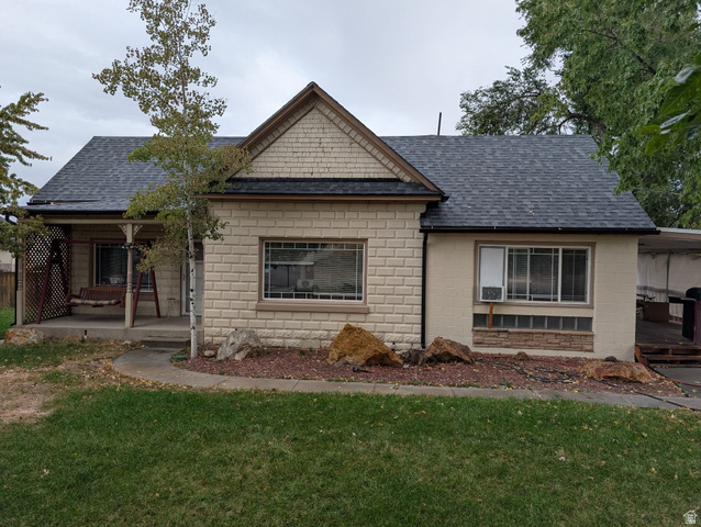 1341 East Crk Road Sandy, UT 84093 - Photo 3 of 24 View of front of home with roof with shingles, a front lawn, and concrete block siding