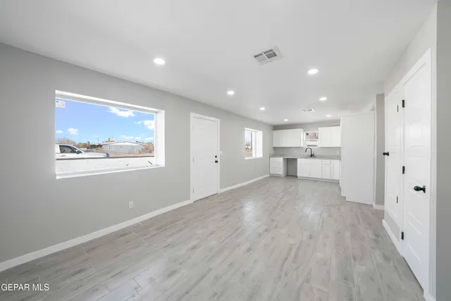 a view of a kitchen with wooden floor and a window
