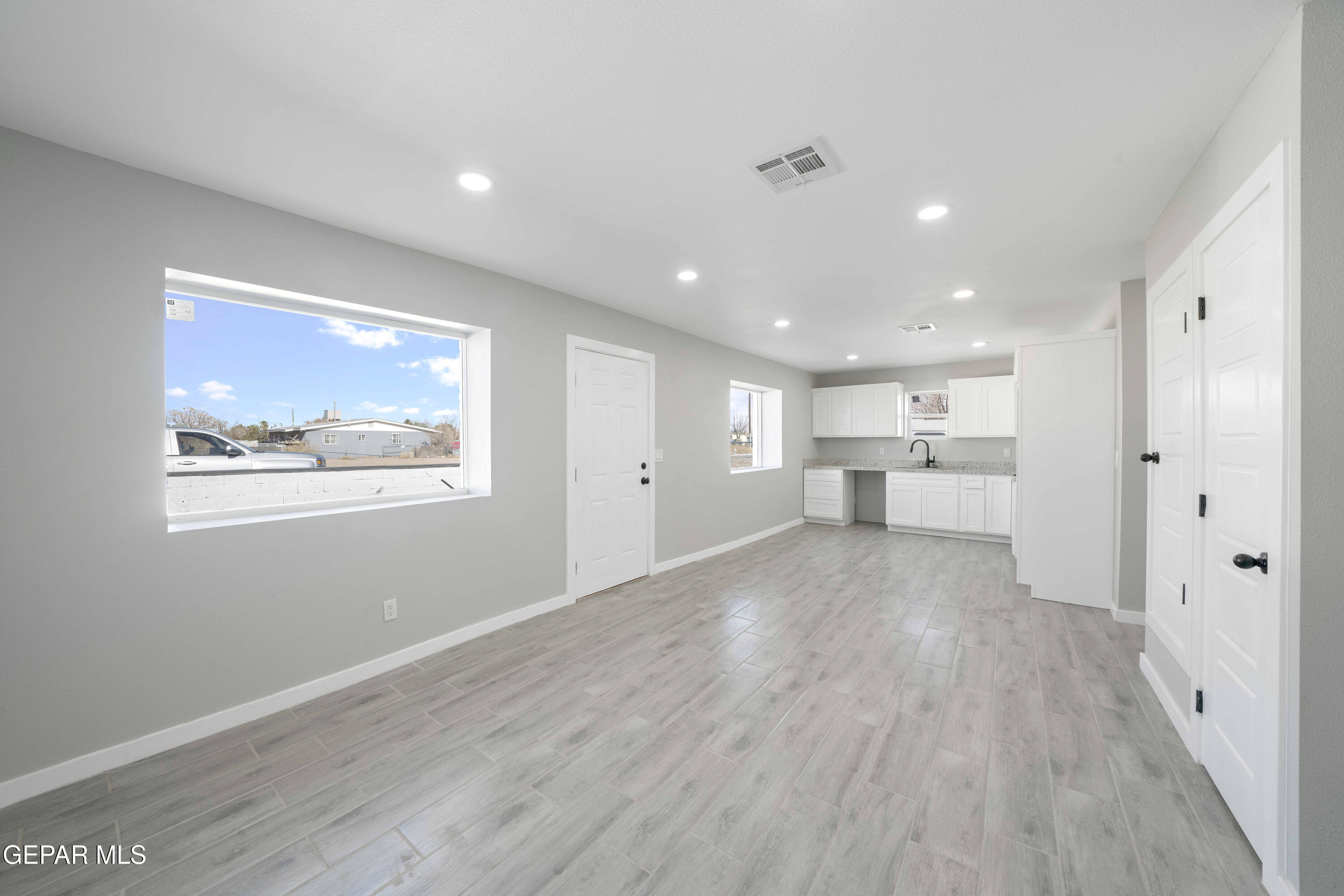 10752 Mellward Road Socorro, TX 79927 - Photo 11 of 37 a view of a kitchen with wooden floor and a window