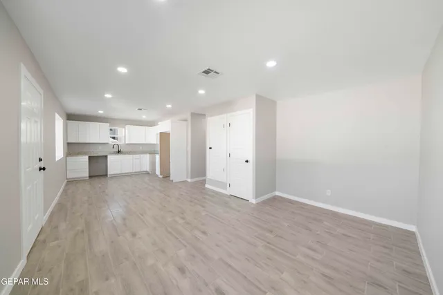 a view of kitchen with refrigerator and a window
