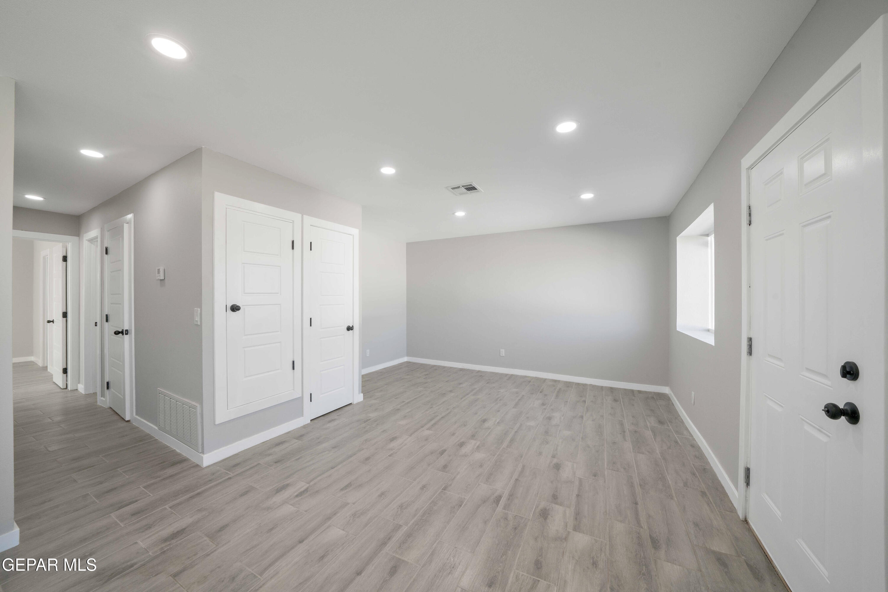 10752 Mellward Road Socorro, TX 79927 - Photo 18 of 37 wooden floor in an empty room with a window